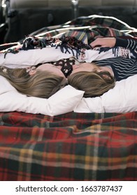 Young Couple Sleeping In The Back Of Their Car.