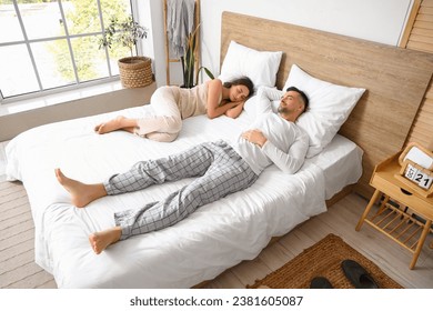 Young couple sleeping in bedroom - Powered by Shutterstock