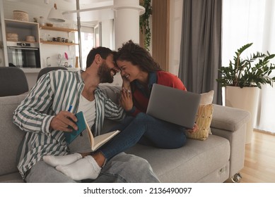 Young Couple Small Business Owners Working From Home. Married Man And Woman Sitting On Sofa In Apartment Work On New Commercial Ideas And Strategy For Web Site And Company They Own. Selective Focus.