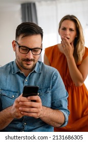 Young Couple With Smartphone Having Quarell And Marriage Conflict Because Of Cheating