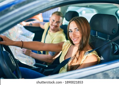 Young Couple Smiling Happy Driving Car And Looking At City Map.