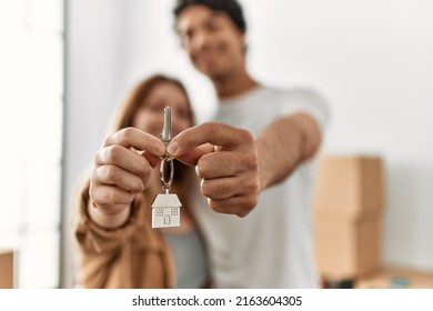 Young couple smiling happy holding key of new home. - Shutterstock ID 2163604305
