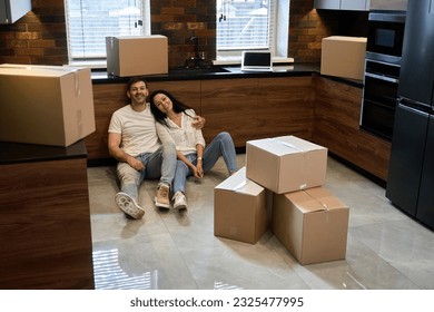 Young couple smiling while moving into a new house