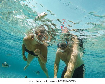 Young couple snorkeling selfie underwater camera on the coral reef in ocean of Egypt Hurghada travel concept vacation - Shutterstock ID 1619874025