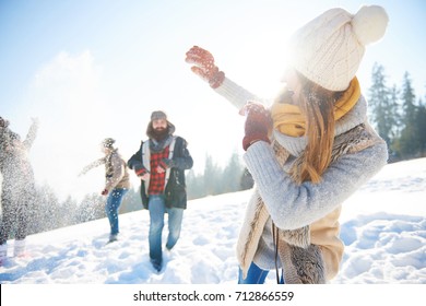 Young couple in snowball fight  - Powered by Shutterstock