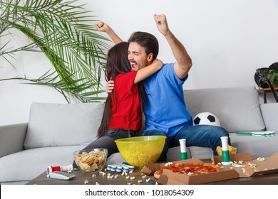 Young Couple Sport Fans Watching Match Hugging Cheerful