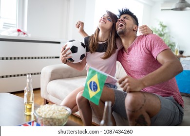 Young Couple Sport Fans Watching Match On Television