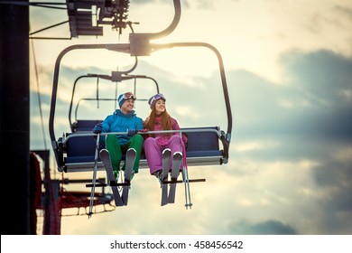 Young couple in sportswear on a lift