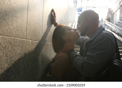  A young couple is standing on the stairs of the underpass. Kiss moment. High quality photo
