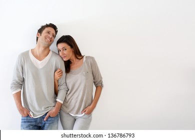 Young couple standing on white background