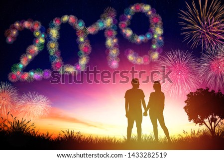 young couple standing and watching the fireworks for 2019 year