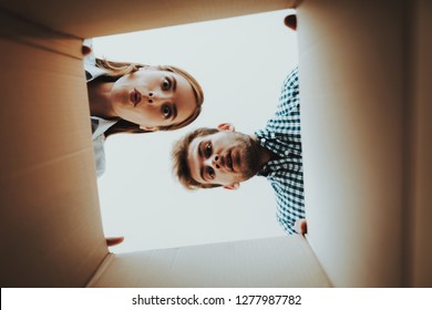 Young Couple Stare. View From Empty Orange Box. Newlyweds In A New Housing. Domestic Problems. New Life. Personal Flat. Nothing Inside. Shocked Sweethearts. . Missed Things.