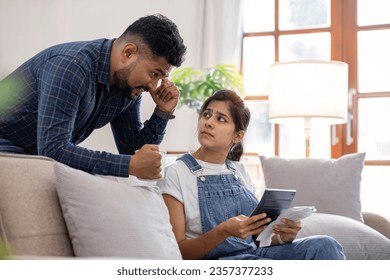 Young couple stressing about bills and invoices in living room Increased expenses cause stress. - Shutterstock ID 2357377233