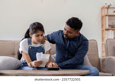 Young couple stressing about bills and invoices in living room Increased expenses cause stress. - Shutterstock ID 2357722501