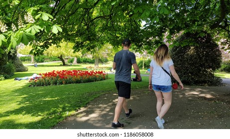 Young Couple Strolling Through Park Under Stock Photo 1186058008 ...