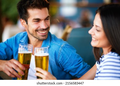 Young couple at a summer bar toast with beer - Shutterstock ID 2156583447