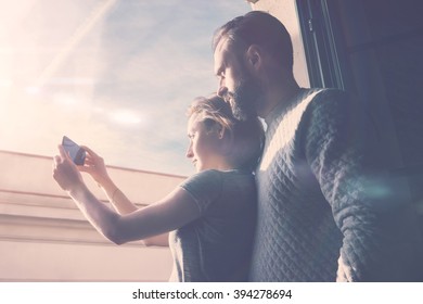 Young Couple Summer Journey. Photo Woman And Bearded Man Making Selfie Mobile Phone. Using Contemporary Smartphone, Smiling. Horizontal, Film Effect. 