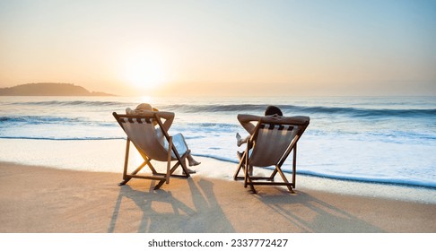 Young couple sunbathing on beach chair - Powered by Shutterstock