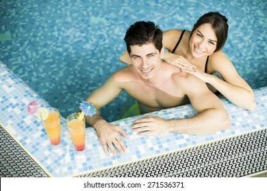 Young Couple In The Swimming Pool