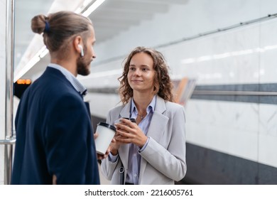 Young Couple With Takeaway Coffee Standing On Subway Platform .