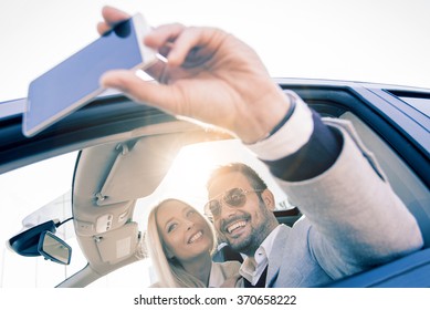 Young Couple Taking A Selfie In Car