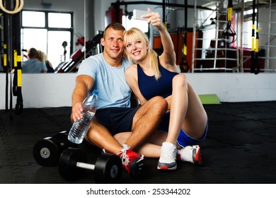 Young Couple Taking A Selfie At Gym