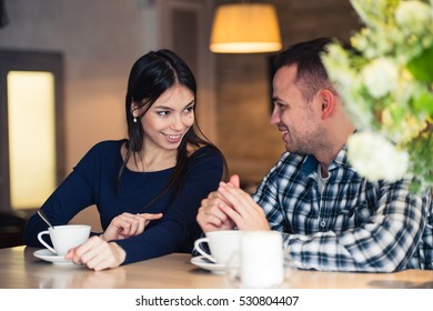 Young Couple Talking In Coffee Shop