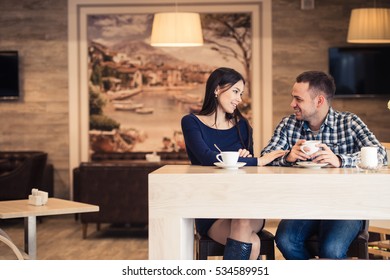 Young Couple Talking In Coffee Shop