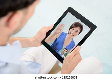 A Young Couple Talking To Each Other Via Online Video Chat.