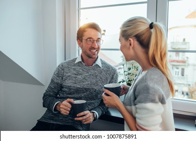 Young Couple Talking Over Morning Coffee