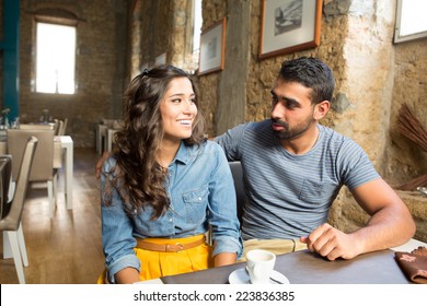 Young Couple Talking In Restaurant And Cafe