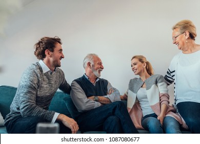 Young couple talking with their parents