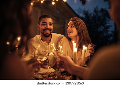 Young Couple And Their Friends Having Dinner Outside