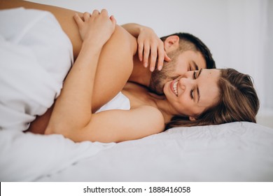 Young couple together lying in bed
