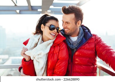 Young couple together at rooftop smiling