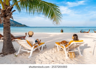 Young couple tourist relaxing and enjoying at beautiful tropical white sand beach with transparent sea, Summer vacation and Travel concept - Powered by Shutterstock