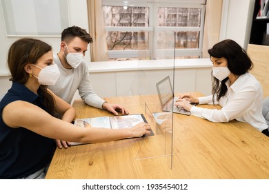 Young Couple With Travel Agent Wearing Face Mask