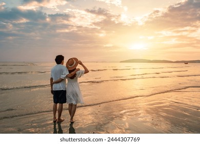 Young couple traveler looking beautiful sunset on the beach, Couple on vacation in summer concept - Powered by Shutterstock