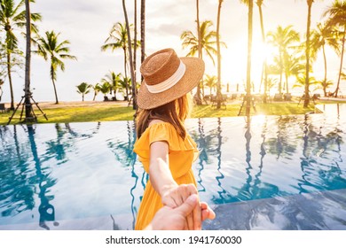 Young Couple Traveler Relaxing And Enjoying The Sunset By A Tropical Resort Pool While Traveling For Summer Vacation