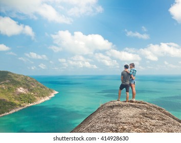 Young Couple Of Travelers On A Hill With Stunning Views Of The Ocean