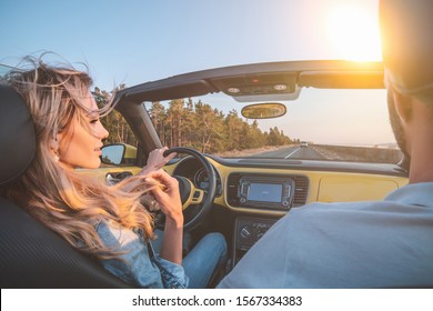The young couple traveling by a cabriolet - Shutterstock ID 1567334383