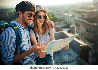 Young Couple Travelling With A Map In The City