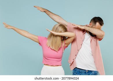 Young Couple Two Friends Family Man Woman Wearing Casual Clothes Doing Dab Hip Hop Dance Hands Move Gesture Youth Sign Hide Cover Face Together Isolated On Pastel Plain Light Blue Background Studio