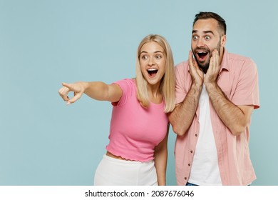 Young Couple Two Friends Family Surprised Man Woman In Casual Clothes Point Finger Aside On Workspace Together Isolated On Pastel Plain Light Blue Background Studio Portrait People Lifestyle Concept