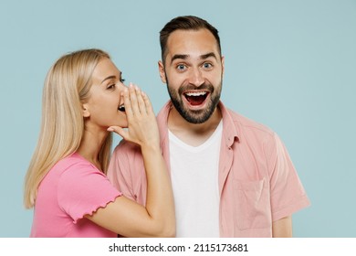 Young Couple Two Friends Family Man Woman In Casual Clothes Whisper Gossip And Tells Secret Behind Her Hand Sharing News Together Isolated On Pastel Plain Light Blue Color Background Studio Portrait