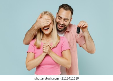 Young Couple Two Friends Family Man Woman In Casual Clothes Together Make Surprise Gift Car Key Close Eyes Isolated On Pastel Plain Light Blue Color Background Studio Portrait People Lifestyle Concept