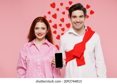 Young Couple Two Friends Woman Man In Shirt Use Hold In Hand Mobile Cell Phone With Blank Screen Workspace Area Isolated On Plain Pastel Pink Background Valentine's Day Birthday Holiday Party Concept.