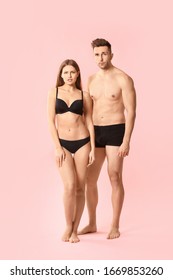 Young Couple In Underwear On Color Background