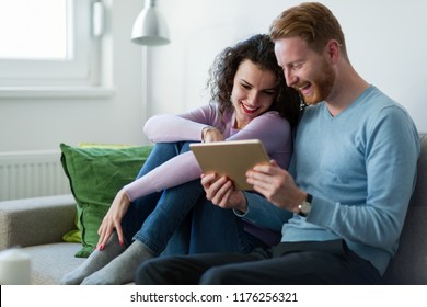 Young couple using digital tablet at home