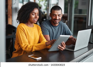 Young couple using digital tablet in café - Powered by Shutterstock